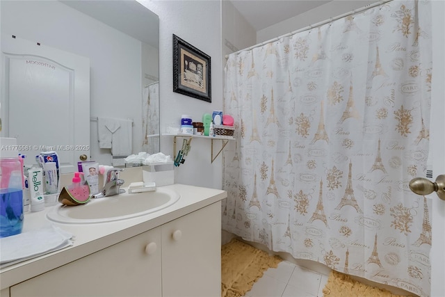 bathroom featuring a shower with shower curtain, tile patterned floors, and vanity
