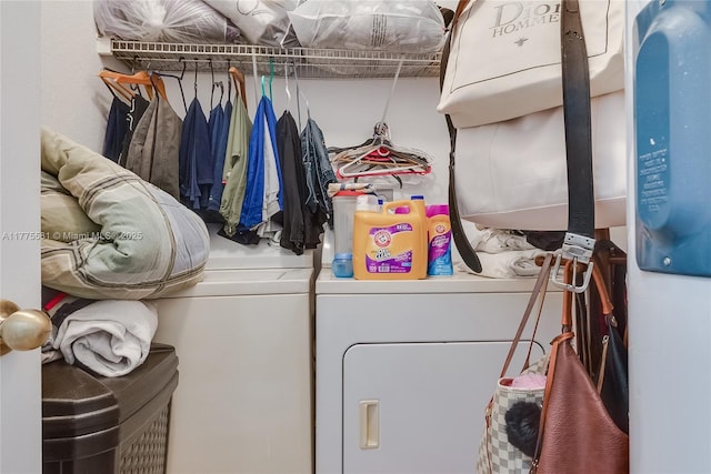 clothes washing area featuring separate washer and dryer and laundry area