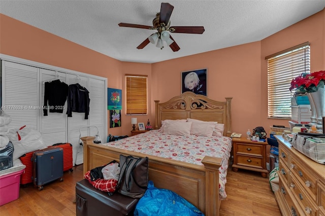 9180 SW 75th St, Miami, FL 33173 - bedroom with light wood-style floors, a closet, ceiling fan, and a textured ceiling