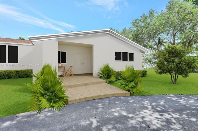 exterior space featuring a yard and stucco siding