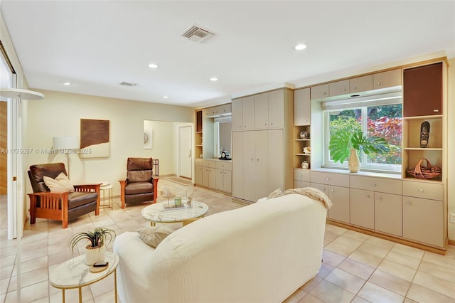 living area with light tile patterned floors, visible vents, and recessed lighting