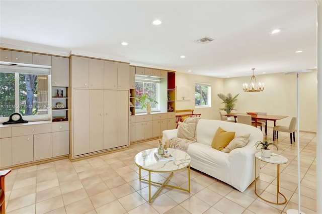 living room with visible vents, recessed lighting, and a chandelier