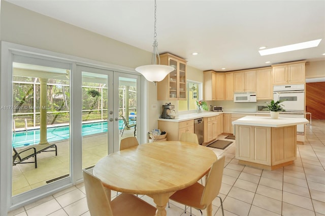 kitchen featuring plenty of natural light, light brown cabinets, french doors, and white appliances