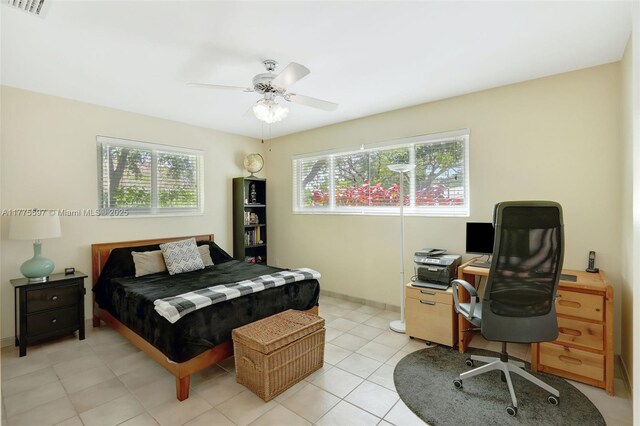 bedroom with ceiling fan, multiple windows, visible vents, and light tile patterned floors