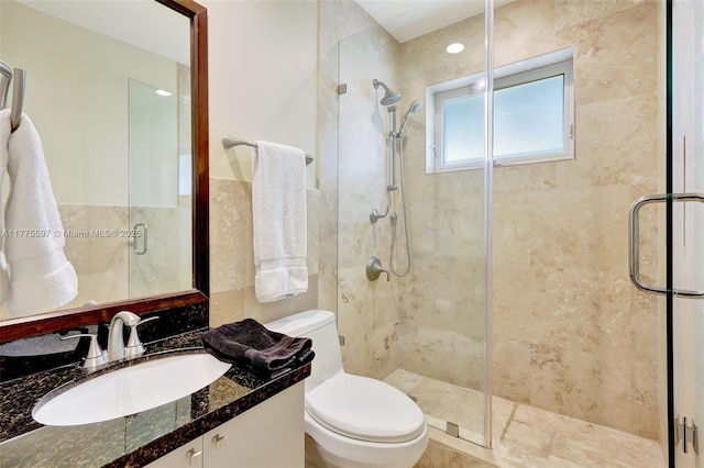 bathroom featuring toilet, tile walls, and a stall shower
