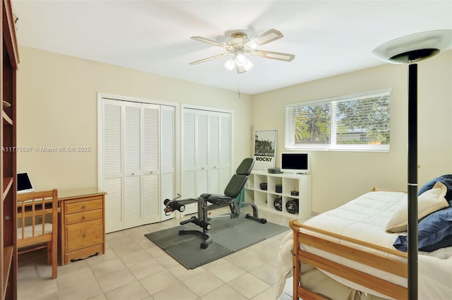 exercise room featuring a ceiling fan and light tile patterned flooring