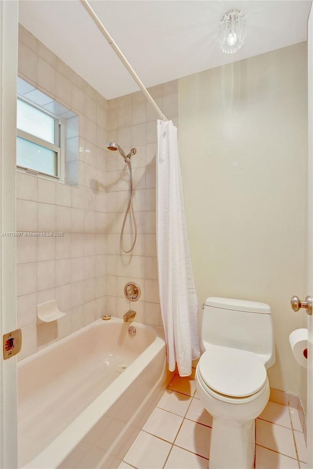 full bathroom with baseboards, tile patterned flooring, shower / bathtub combination with curtain, and toilet