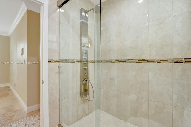 full bathroom featuring baseboards, a stall shower, and ornamental molding