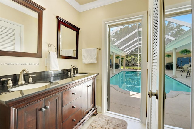 full bathroom with tile patterned flooring, ornamental molding, a sink, and double vanity