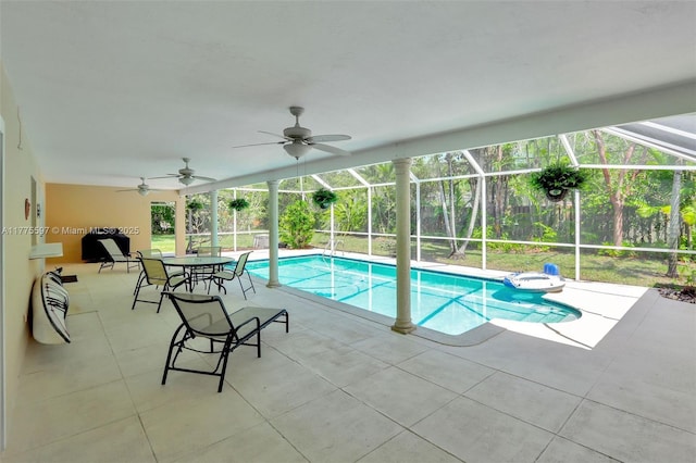 pool with a patio area, a lanai, and a ceiling fan