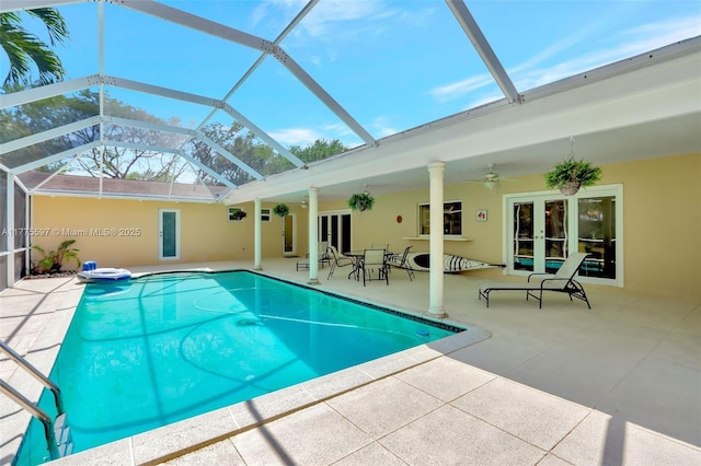 outdoor pool featuring a patio area, french doors, glass enclosure, and ceiling fan