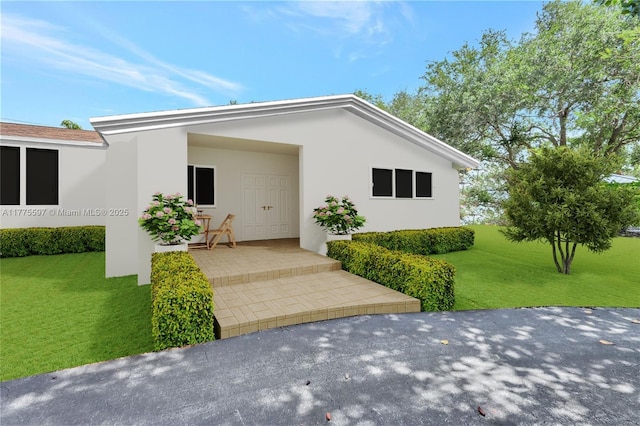 view of front of property with a front lawn and stucco siding