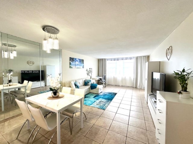 dining room featuring light tile patterned flooring and a textured ceiling