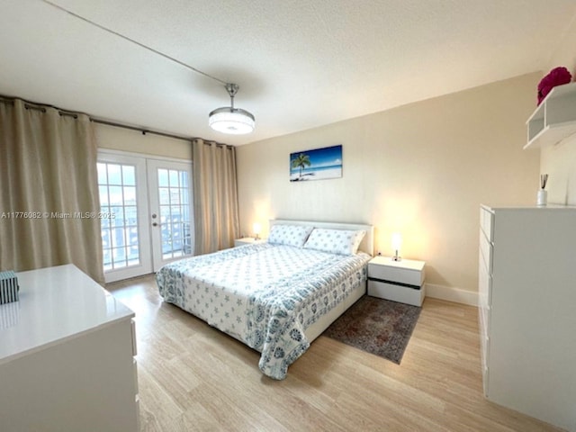 bedroom with baseboards, access to exterior, french doors, and light wood-style floors