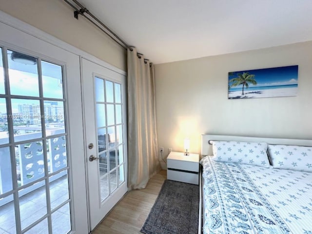 bedroom with wood finished floors and french doors