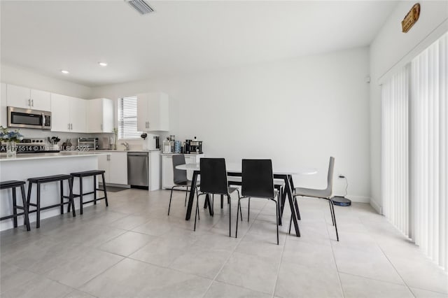 dining space featuring recessed lighting, visible vents, and light tile patterned floors