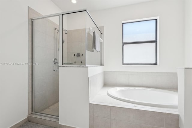 full bath featuring a stall shower, recessed lighting, and a bath