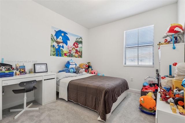 bedroom featuring light carpet and baseboards