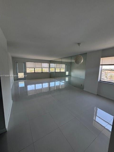 401 SE Golden Isles Dr Unit 712, Hallandale Beach, FL 33009 - tiled spare room featuring plenty of natural light and baseboards