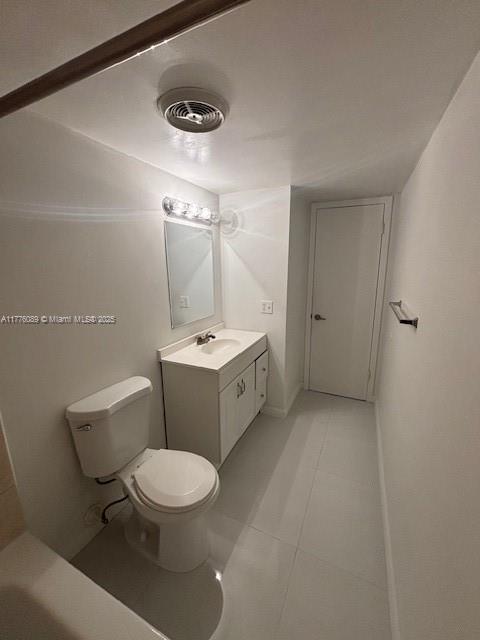 401 SE Golden Isles Dr Unit 712, Hallandale Beach, FL 33009 - bathroom featuring vanity, toilet, and tile patterned flooring
