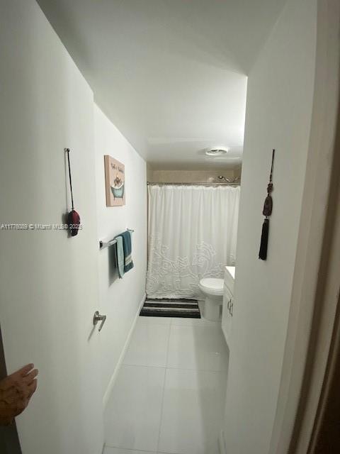 401 SE Golden Isles Dr Unit 712, Hallandale Beach, FL 33009 - full bath with tile patterned flooring, toilet, a shower with shower curtain, and vanity