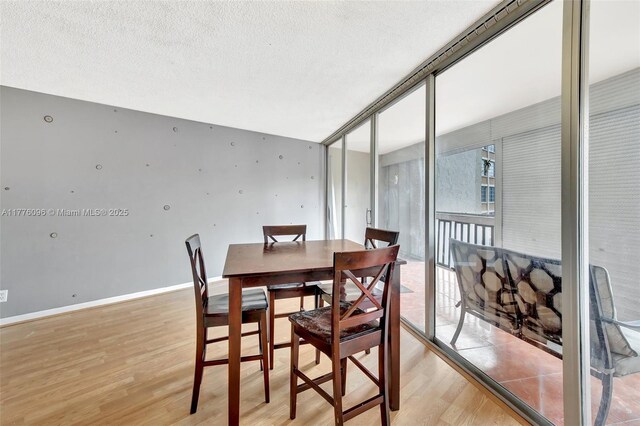 6911 Environ Blvd Unit 3L, Lauderhill, FL 33319 - dining room featuring light wood-type flooring and a textured ceiling