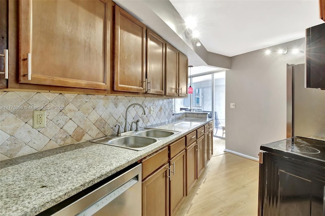 6911 Environ Blvd Unit 3L, Lauderhill, FL 33319 - kitchen with appliances with stainless steel finishes, backsplash, a sink, light wood finished floors, and brown cabinetry