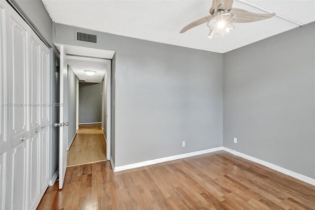 6911 Environ Blvd Unit 3L, Lauderhill, FL 33319 - unfurnished bedroom with light wood-style flooring, baseboards, a closet, and ceiling fan