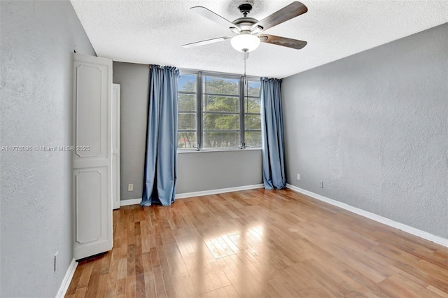 6911 Environ Blvd Unit 3L, Lauderhill, FL 33319 - unfurnished room featuring a textured wall, ceiling fan, a textured ceiling, light wood-style floors, and baseboards