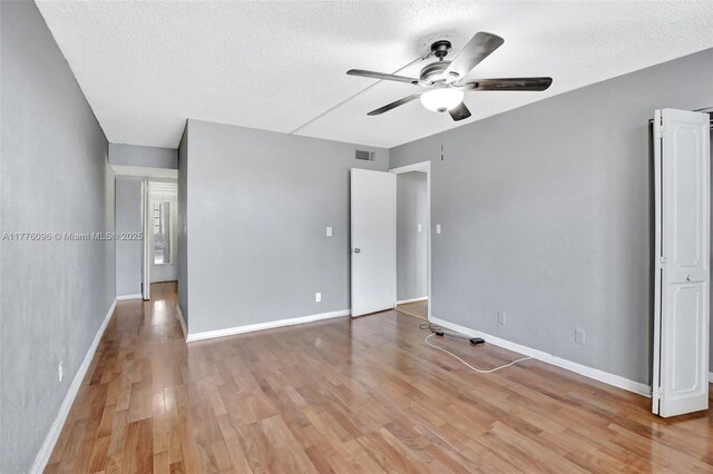 6911 Environ Blvd Unit 3L, Lauderhill, FL 33319 - unfurnished bedroom with a textured ceiling, light wood-style flooring, baseboards, and ceiling fan