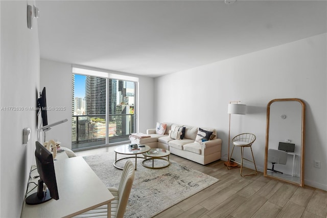 living area with expansive windows and light wood-style flooring