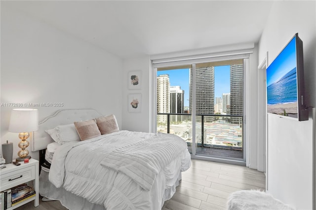 bedroom featuring access to outside and light wood-style floors