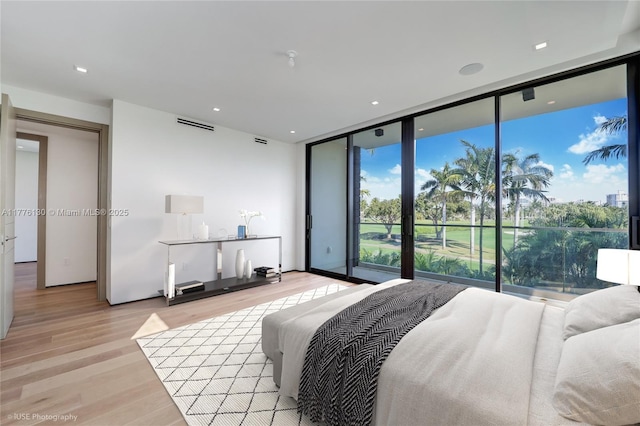 5825 Alton Rd, Miami Beach, FL 33140 - bedroom with expansive windows, light wood-type flooring, access to exterior, and visible vents