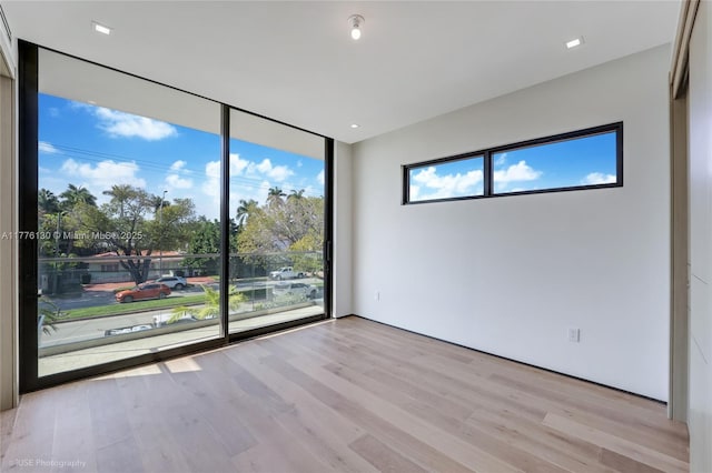 5825 Alton Rd, Miami Beach, FL 33140 - empty room with light wood-style floors and floor to ceiling windows