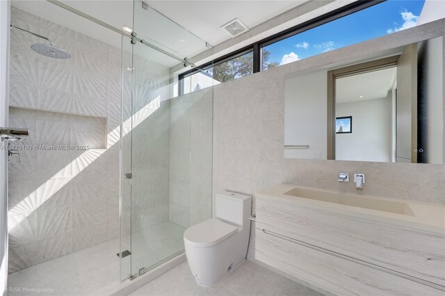 5825 Alton Rd, Miami Beach, FL 33140 - full bath with a stall shower, vanity, tile walls, toilet, and visible vents