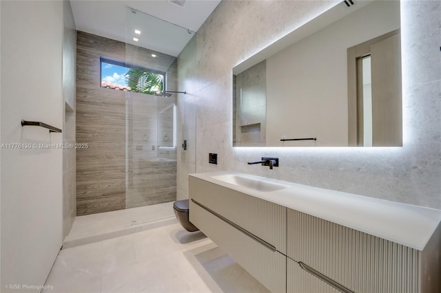 5825 Alton Rd, Miami Beach, FL 33140 - full bath with tile patterned floors, toilet, tile walls, vanity, and a walk in shower