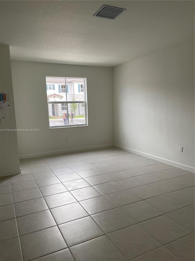 12179 NW 23rd Ct, Miami, FL 33167 - tiled spare room featuring baseboards
