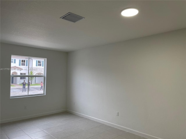 12179 NW 23rd Ct, Miami, FL 33167 - unfurnished room with light tile patterned floors and baseboards