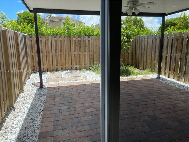 12179 NW 23rd Ct, Miami, FL 33167 - fenced backyard featuring ceiling fan and a patio
