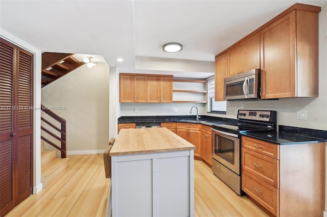 400 Valencia Ave Unit 2, Coral Gables, FL 33134 - kitchen featuring appliances with stainless steel finishes, open shelves, light wood-style floors, wood counters, and recessed lighting