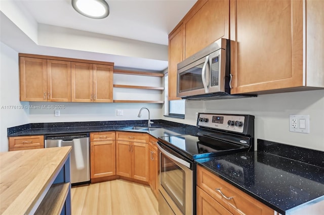 400 Valencia Ave Unit 2, Coral Gables, FL 33134 - kitchen with stainless steel appliances, a sink, open shelves, dark stone counters, and light wood finished floors