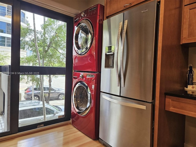 400 Valencia Ave Unit 2, Coral Gables, FL 33134 - washroom with stacked washer and clothes dryer and light wood-style flooring