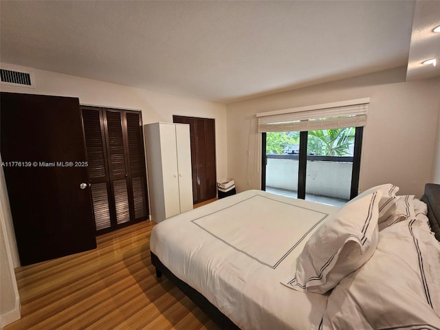 400 Valencia Ave Unit 2, Coral Gables, FL 33134 - bedroom featuring wood finished floors and two closets