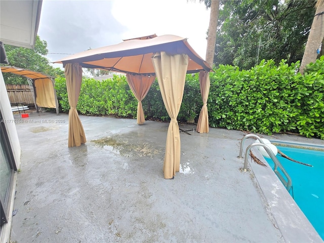 view of patio featuring a gazebo and fence