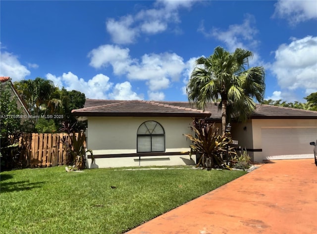 10420 SW 160th Ct, Miami, FL 33196 - view of front of property with a garage, fence, stucco siding, a front lawn, and driveway