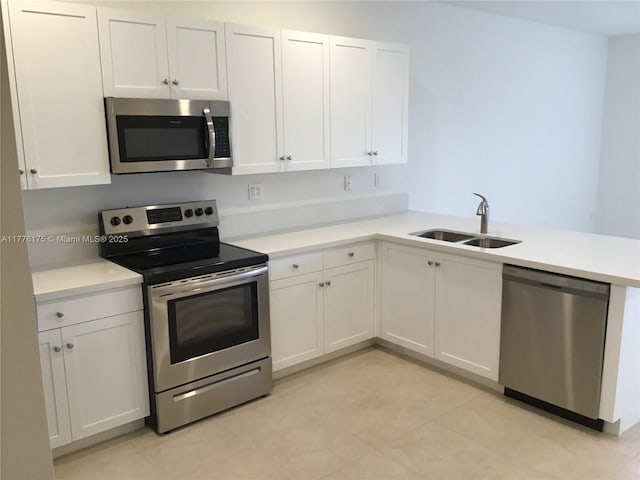 11378 SW 254th Ter, Homestead, FL 33032 - kitchen with white cabinets, light countertops, a sink, and appliances with stainless steel finishes