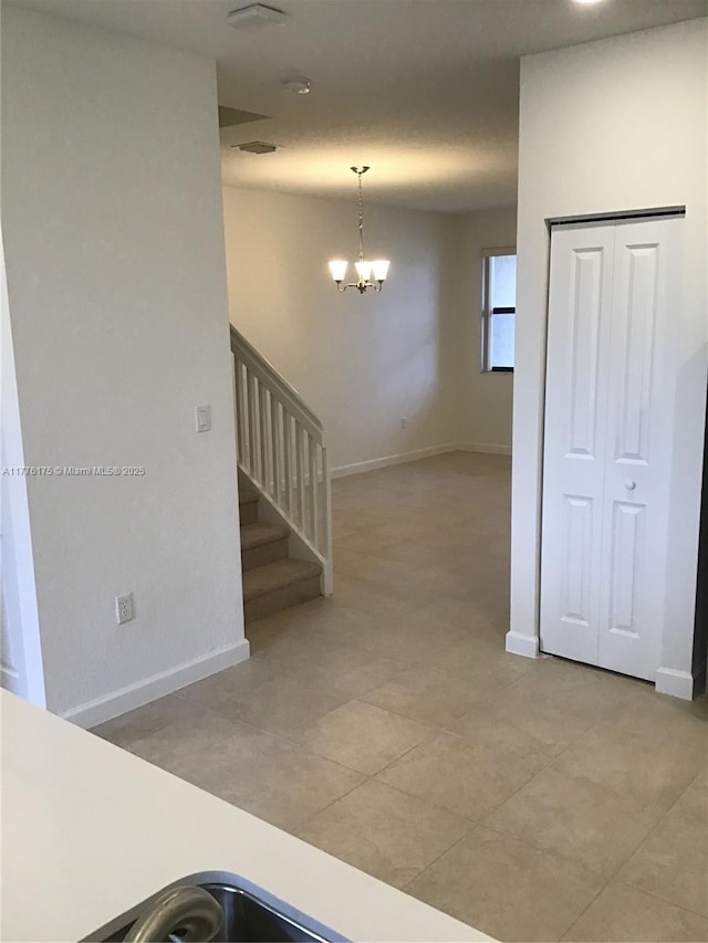 11378 SW 254th Ter, Homestead, FL 33032 - interior space featuring baseboards and an inviting chandelier