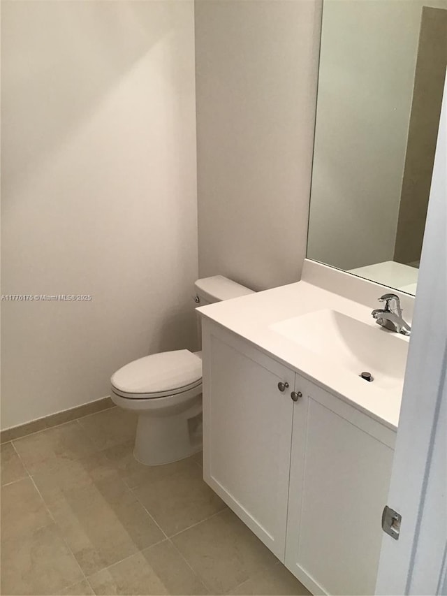 11378 SW 254th Ter, Homestead, FL 33032 - half bathroom with toilet, vanity, tile patterned floors, and baseboards