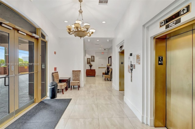 2280 SW 32nd Ave Unit 305, Miami, FL 33145 - hallway with elevator, a chandelier, light tile patterned floors, baseboards, and recessed lighting