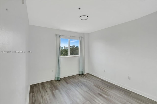 2280 SW 32nd Ave Unit 305, Miami, FL 33145 - spare room featuring wood finished floors and baseboards